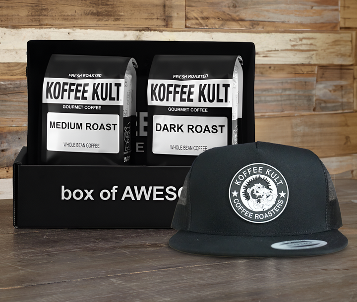Koffee Kult coffee packages and a cap on a wooden surface with a wooden background