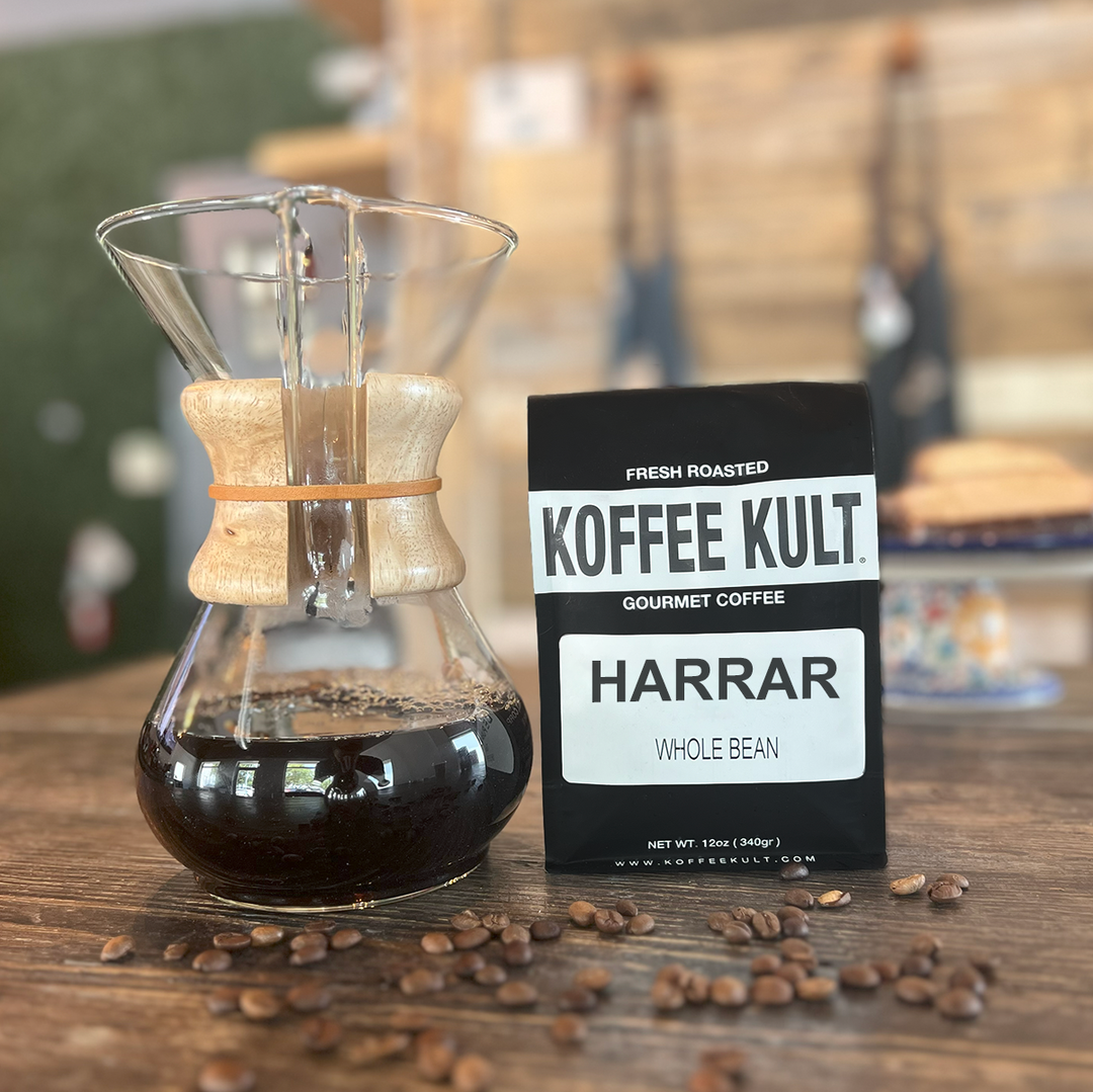 Coffee brewing apparatus with Koffee Kult Harrar coffee beans on a wooden surface