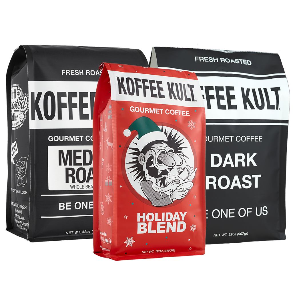 Three bags of gourmet coffee from Koffee Kult are displayed against a white background. In the foreground is a red bag labeled 'Holiday Blend', flanked by two larger black bags labeled 'Fresh Roasted' and 'Medium Roast' and 'Dark Roast' respectively.