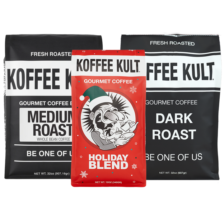 Three bags of Koffee Kult Gourmet Coffee are displayed against a white background: a red 'Holiday Blend' bag in the center, flanked by two black bags labeled 'Medium Roast' and 'Dark Roast'.
