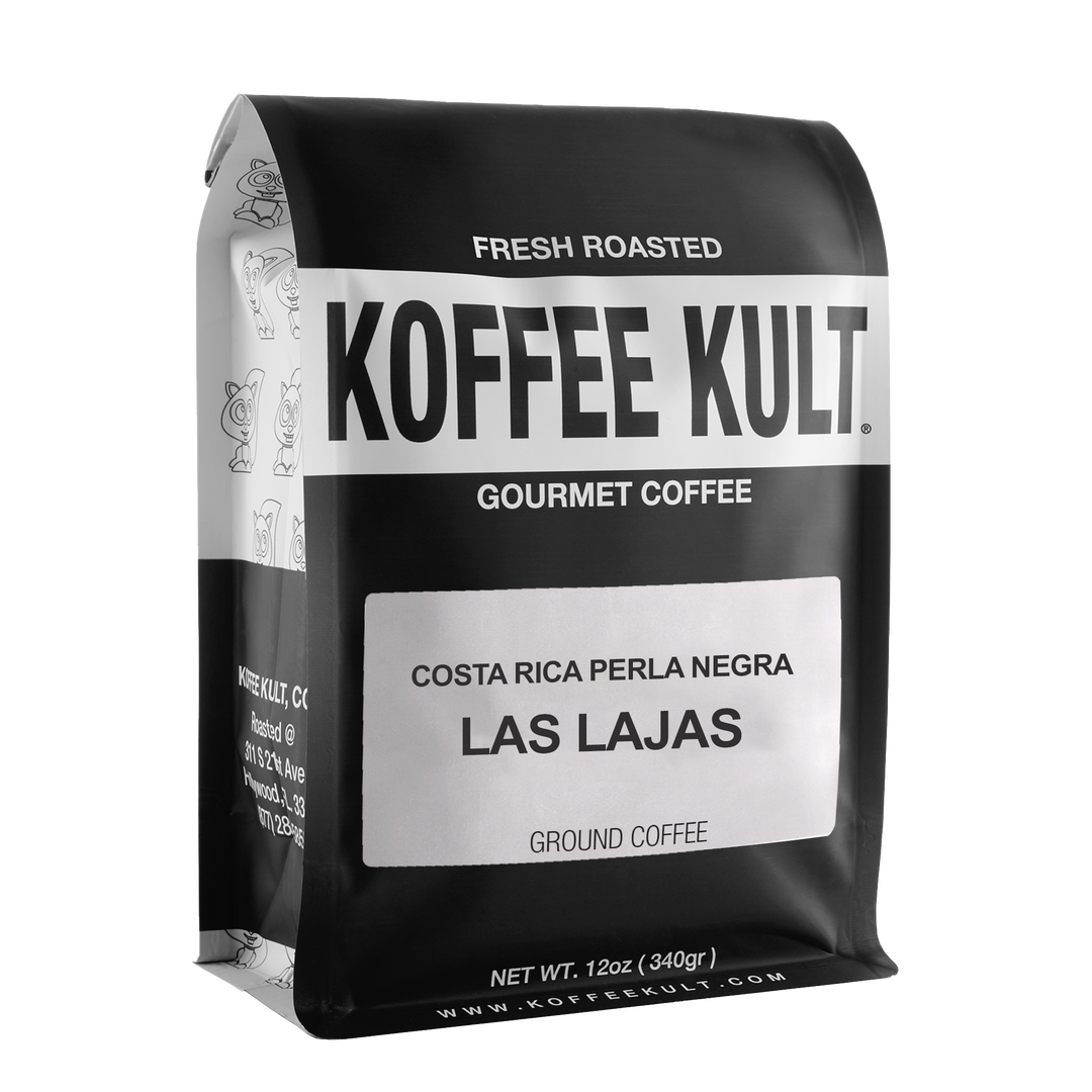 A 12oz bag of Koffee Kult Las Lajas gourmet coffee, featuring a matte black bag with a white label and bold black text, isolated on a white background.