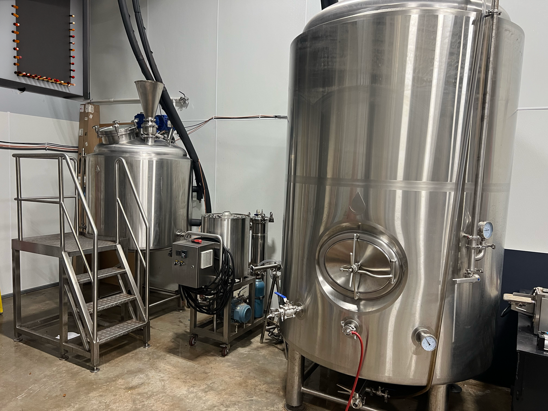 cold brew coffee Brewery with large stainless steel tanks and equipment.