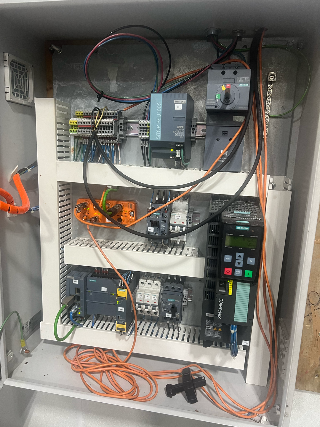 Electrical panel with various components and wiring inside a cabinet